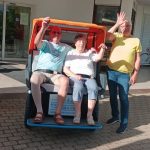 Rikscha mit zwei Fahrgästen und Fahrer.